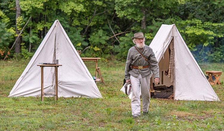 Tom Bassford, a civil war reenactor, walks away from his tent during the second  annual Civil War Encampment. 