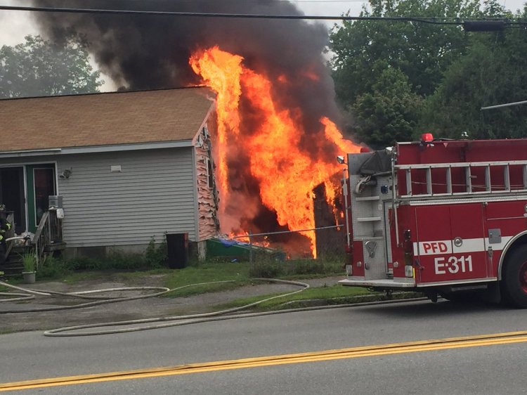 A fire that started in a shed engulfs a house on Berkshire Road in Portland.