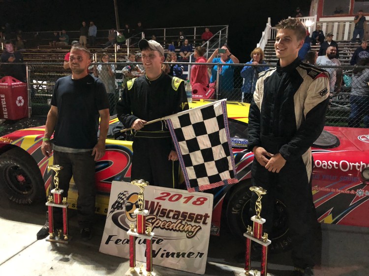Will Collins, center, stands with Andrew McLauglin, left, and James Baker in victory lane at Wiscasset Speedway on Saturday.