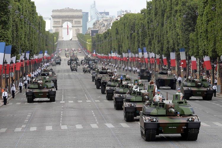 Tanks drive down the Champs Elysees avenue during the Bastille Day parade in Paris in 2017. Trump attended the parade and said later  "We're going to have to try and top it."