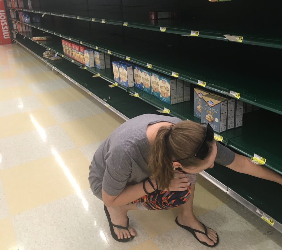 Kaylie Conti, who recently moved from Winslow to Wilmington, North Carolina, looks for crackers on a store shelf in Durham, North Carolina. She and her husband, along with their two dogs and a cat, evacuated from their Wilmington home to Durham to avoid the path of Hurricane Florence.