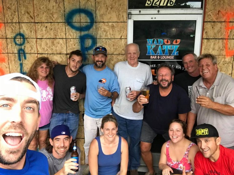 Tim Cramer, far left, a Waterville native, stands outside the Wilmington, North Carolina, bar where he now works, along with a group of customers. Cramer decided to stay in Wilmington even as Hurricane Florence was bearing down on the coastal city.