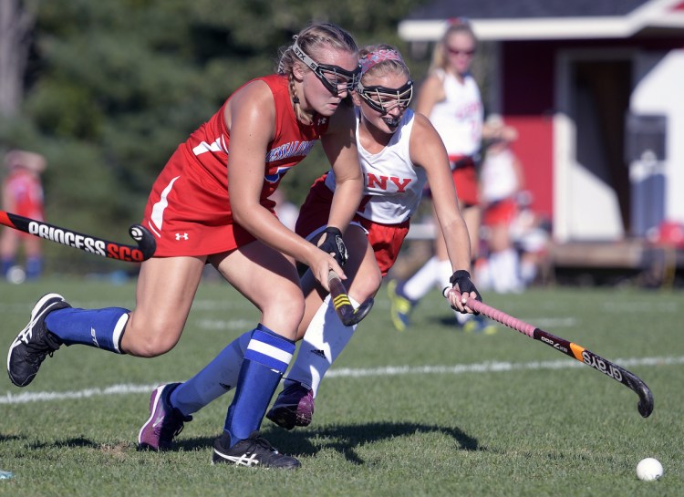 Cony's Julia Reny, right, pursues the ball with Messalonskee's Autumn Littlefield during a field hockey game Thursday in Augusta.
