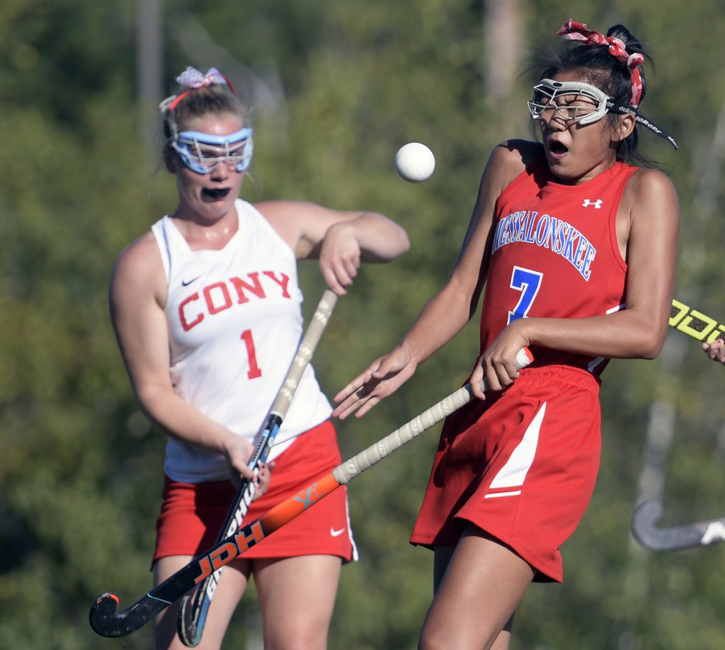Cony's Alexis Couverette, left, and Messalonskee's Annie Corbett collide during a field hockey game Thursday in Augusta