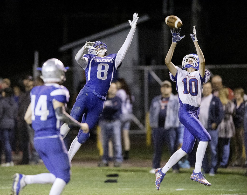 Sun Journal photo by Daryn Slover 
 Liam Rodrigue of Oak Hill hauls in a 35-yard touchdown pass over Keegan Davis of Mountain Valley during the second quarter in Rumford on Friday.