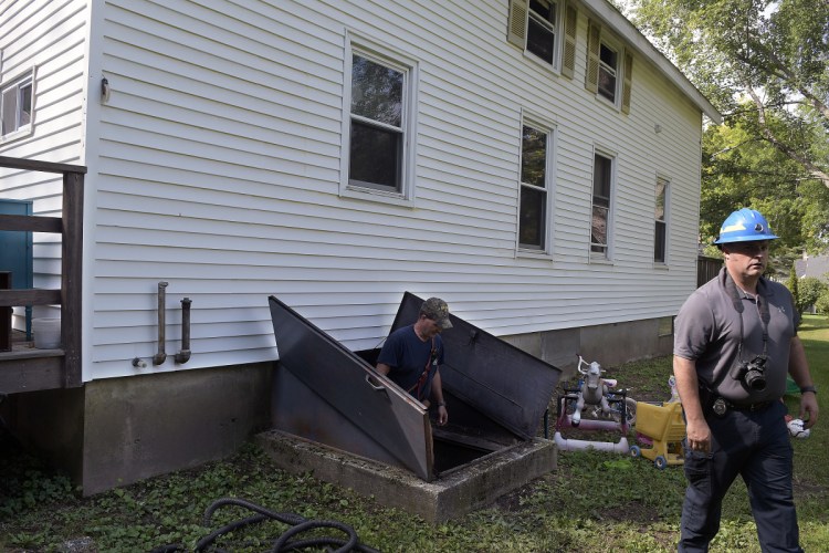 Office of Maine State Fire Marshal investigator Isaiah Peppard, right, and Randolph Fire Department Lt. Dave Libby exit the basement at 24 Closson St. in Randolph on Monday after an early morning fire.
