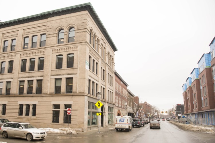 Among the investments that Colby College has made in downtown Waterville since 2015 are the Hains building on the left, at the corner of Main and Appleton streets, home to Portland Pie Co. and CGI Group, and Alfond Commons residential complex, on the right, where Camden National Bank will move.