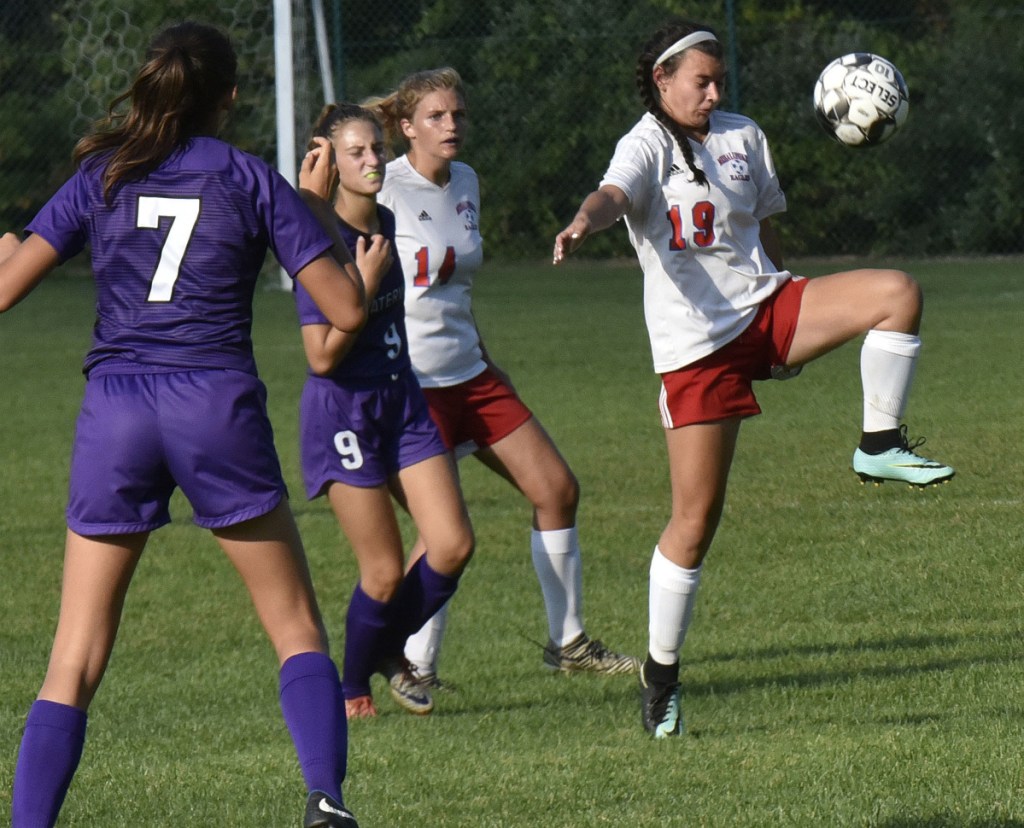 Messalonskee's Lily Wilkie knees the ball as Waterville's Sophia Poole, left, and Jess Bazakas pressure her during a game Tuesday in Waterville.