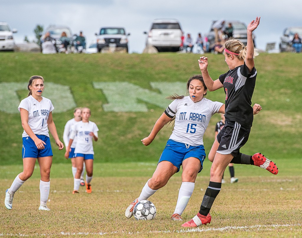 Sun Journal photo by Andree Kehn 
 Mt Abram's Summer Ross, left, tries to maneuver around Lisbon defender Siara Martin during a game Wednesday afternoon.