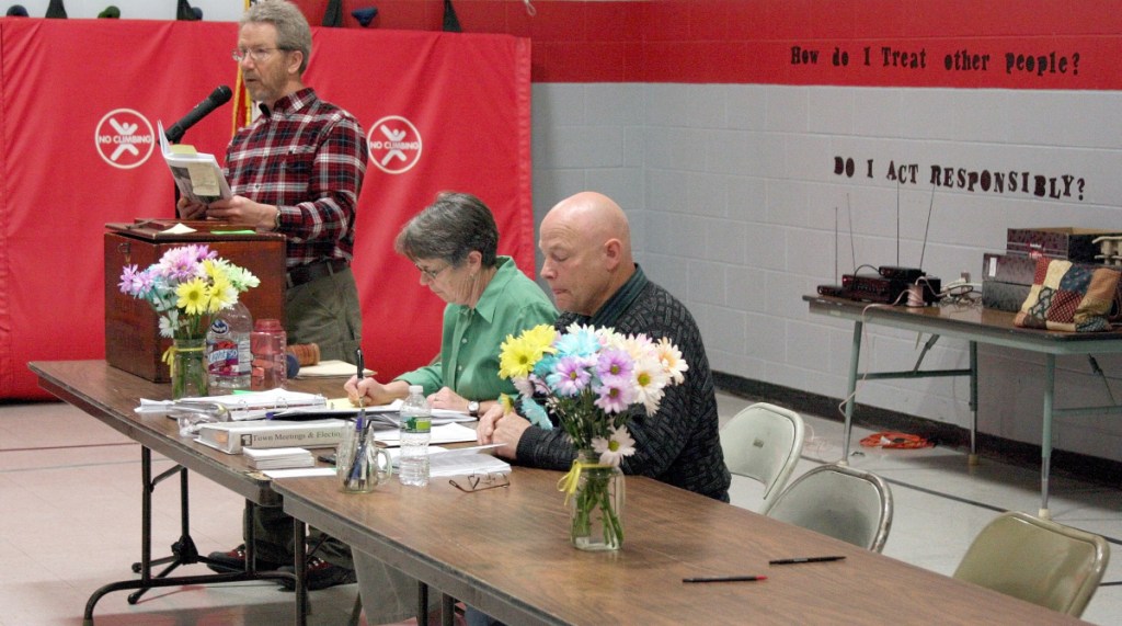 Moderator Don Newell, left, calls for a vote in March 2012 during Town Meeting in Unity, while Town Clerk Susan Lombard and newly elected Selectman Clement Blakney read along. Blakney died Thursday from injuries suffered in a crash in Unity.