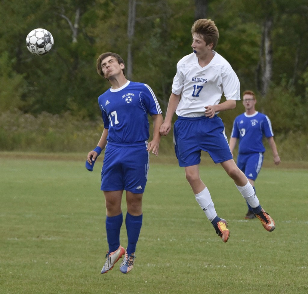 Mt. Abram's Levi Bouchard, left, and Oak Hill's Caleb Leighton jump to head the ball  during a Mountain Valley Conference game Thursday in Salem.