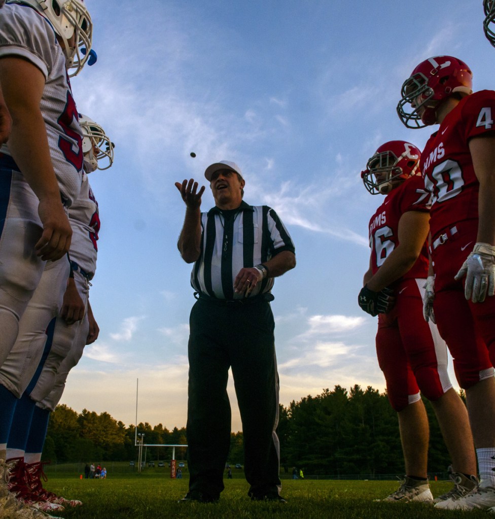Referee Doug Gilbert, center, tosses a coin between Messalonskee, left, and Cony before their Pine Tree Conference B game last Friday in Augusta.