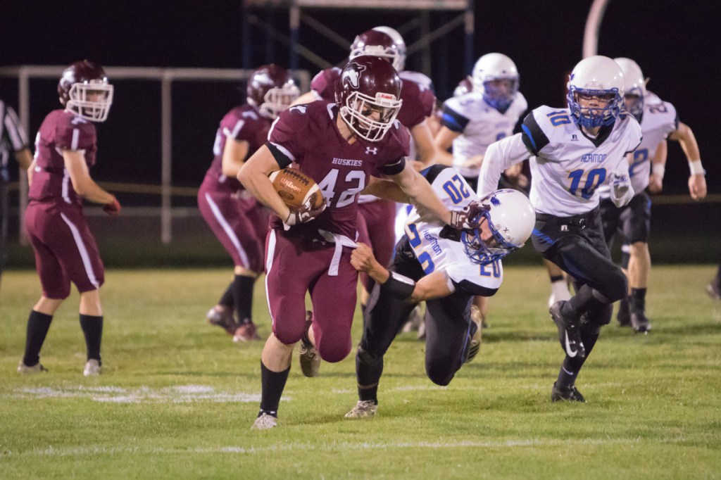 Maine Central Institute ball carrier Tucker Sharples tries to shake off Hermon defender Garrett Trask during a Class C North game Friday night in Pittsfield.