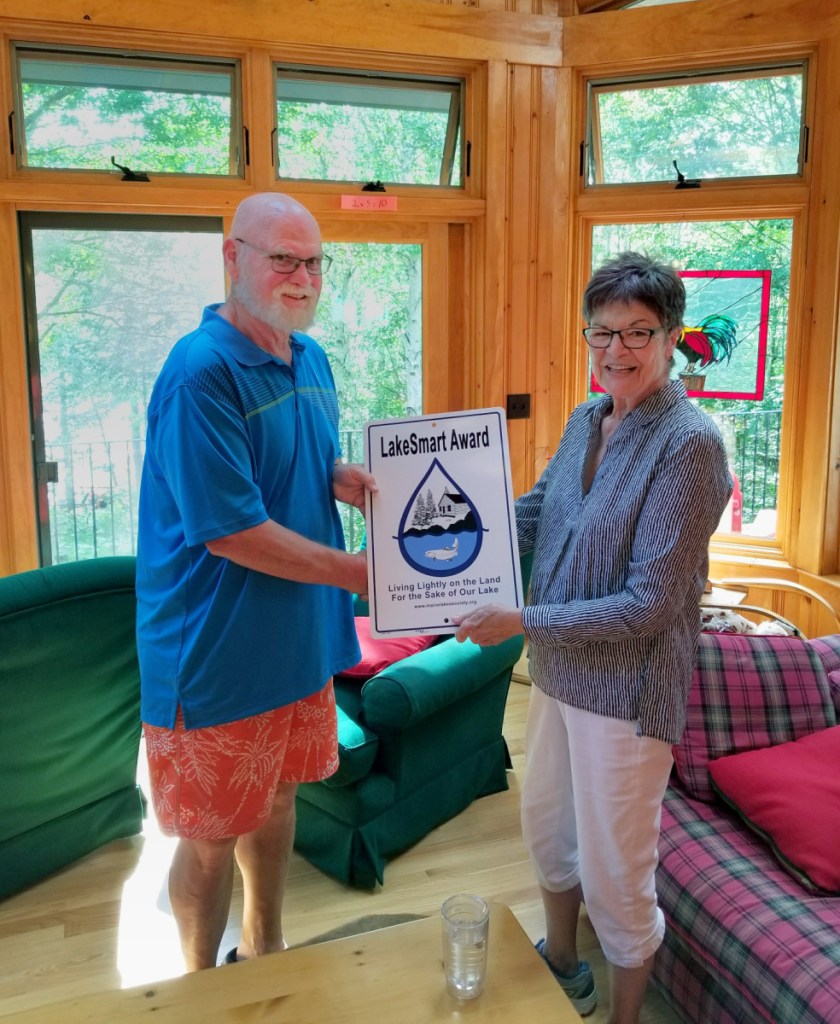 Maggie Shannon, right, presents the LakeSmart award to Earl Sasser, of Pleasant Lake in Otisfield.