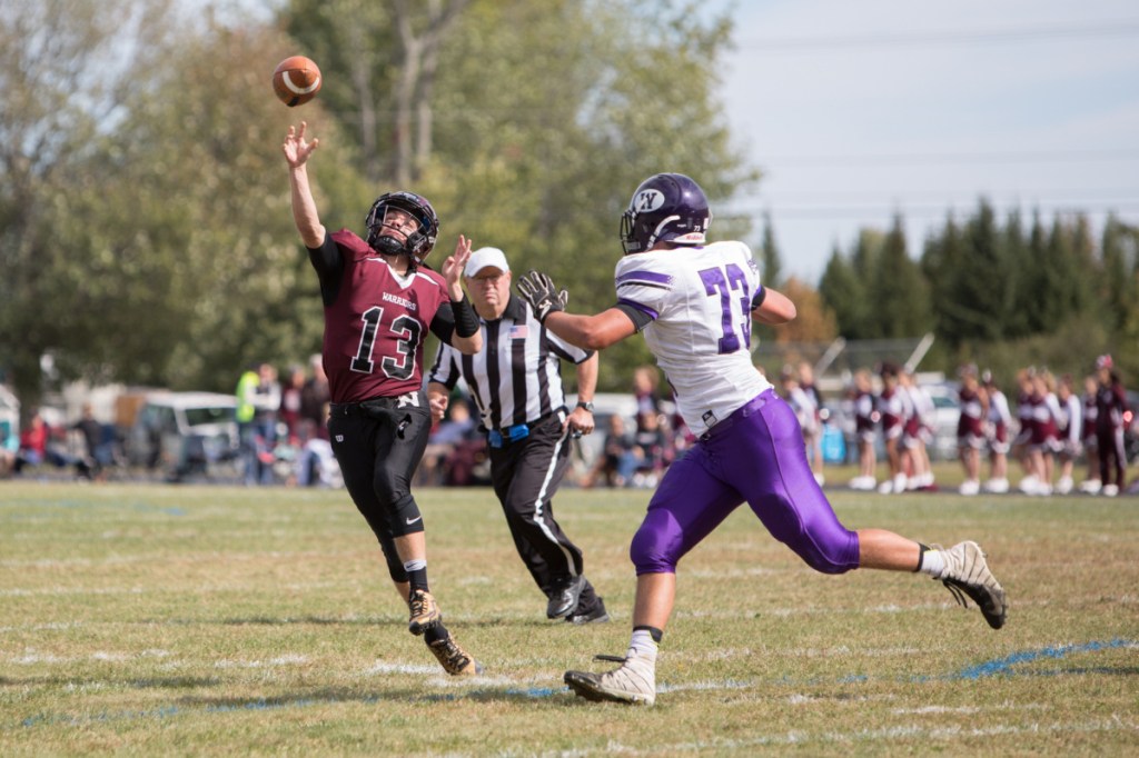 Nokomis quarterback Andrew Haining gets off a pass as Waterville defender Jack Lloyd pursues during a Class C North game Saturday in Newport.