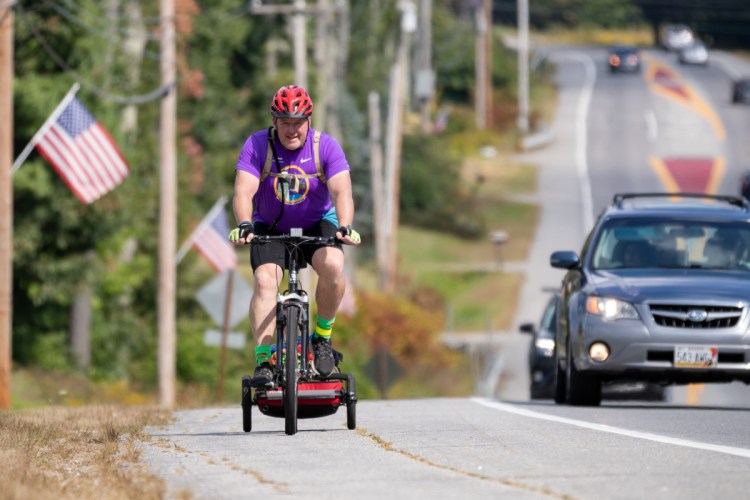 Brian McCarthy peddles up a hill on U.S. Route 1 in Wiscasset on Sept. 16, the sixth day of his ride from Houlton to raise money for the Family Readiness Group of the 488th Military Police Company based in Waterville.