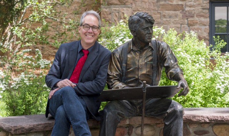 Chuck Plunkett, former editorial page editor for the Denver Post, takes a seat alongside a statue of Robert Frost on the campus of the University of Colorado Boulder where he has joined the College of Media, Communication and Information as director of CU News Corps, an investigative and explanatory news project.