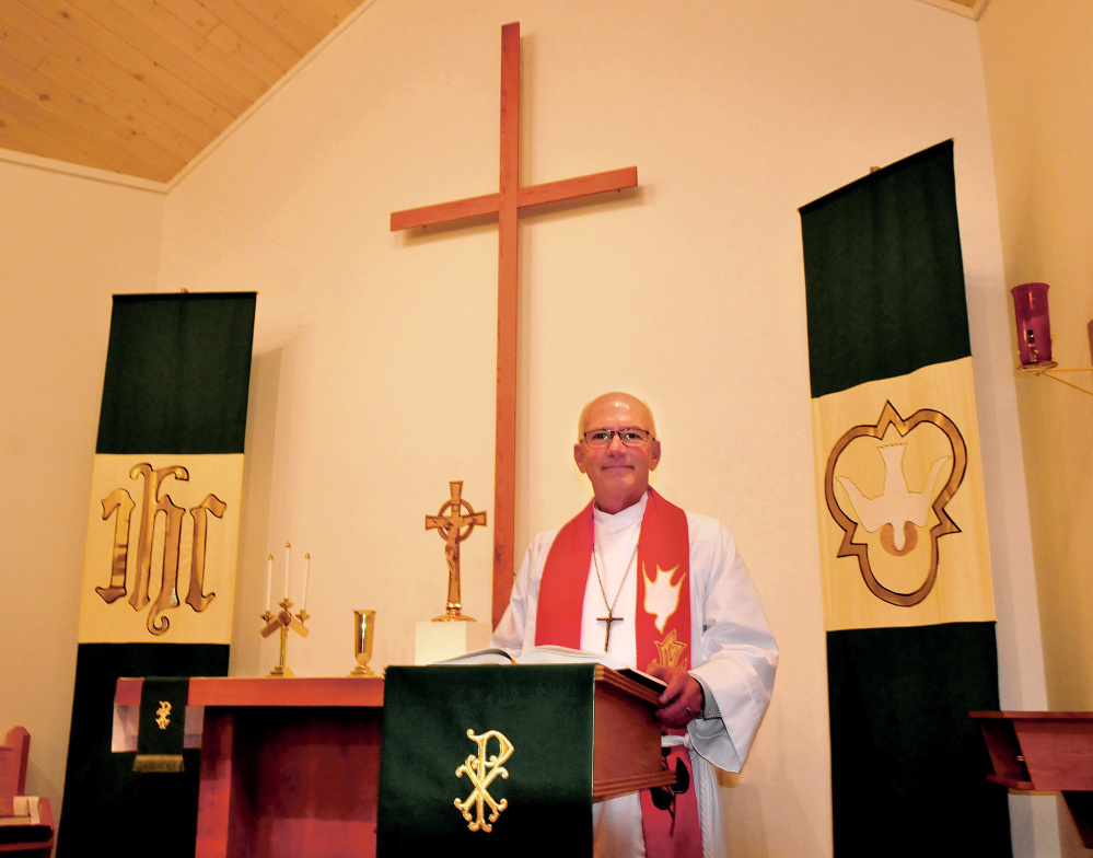 Pastor Paul Nielsen stands in the Lutheran Church of the Resurrection in Waterville in 2017.