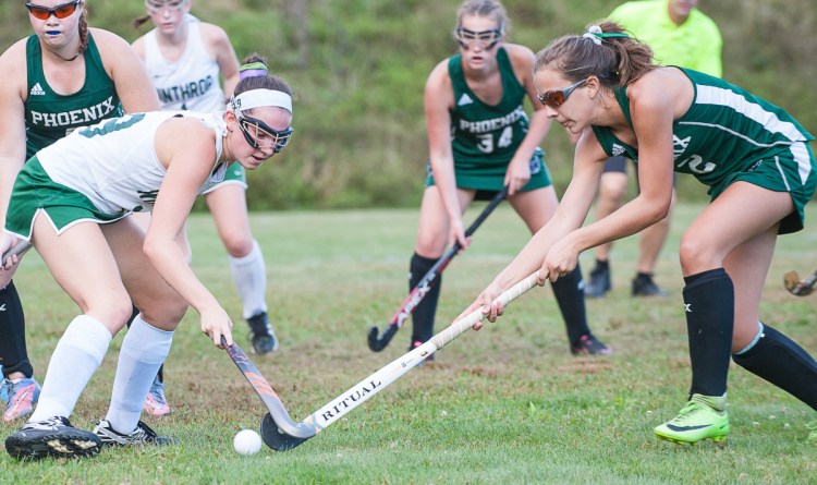 Winthrop's Gia Frances, left and Spruce Mountain's Auri Armandi battle for a loose ball during Wednesday's field hockey game in Winthrop.