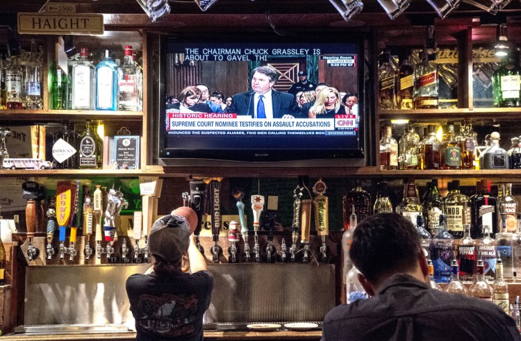 People watch the Brett Kavanaugh Judiciary Committee hearing on television at Mainely Brews on Thursday.
