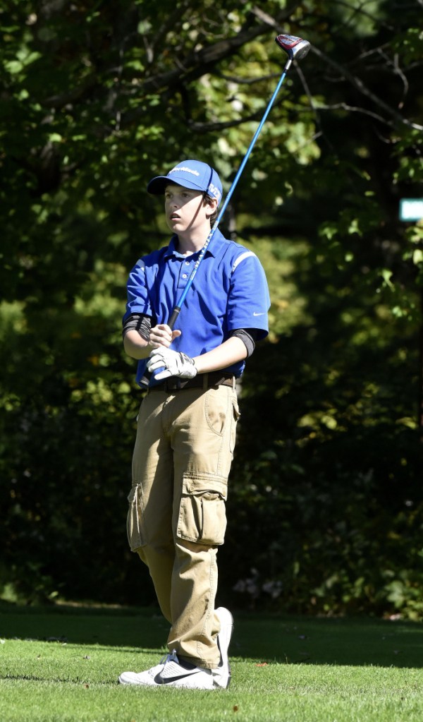 Staff photo by David Leaming 
 Madison's Caleb Cowan watches his shot during the Mountian Valley Conference championships Thursday at Natanis Golf Course in Vassalboro.