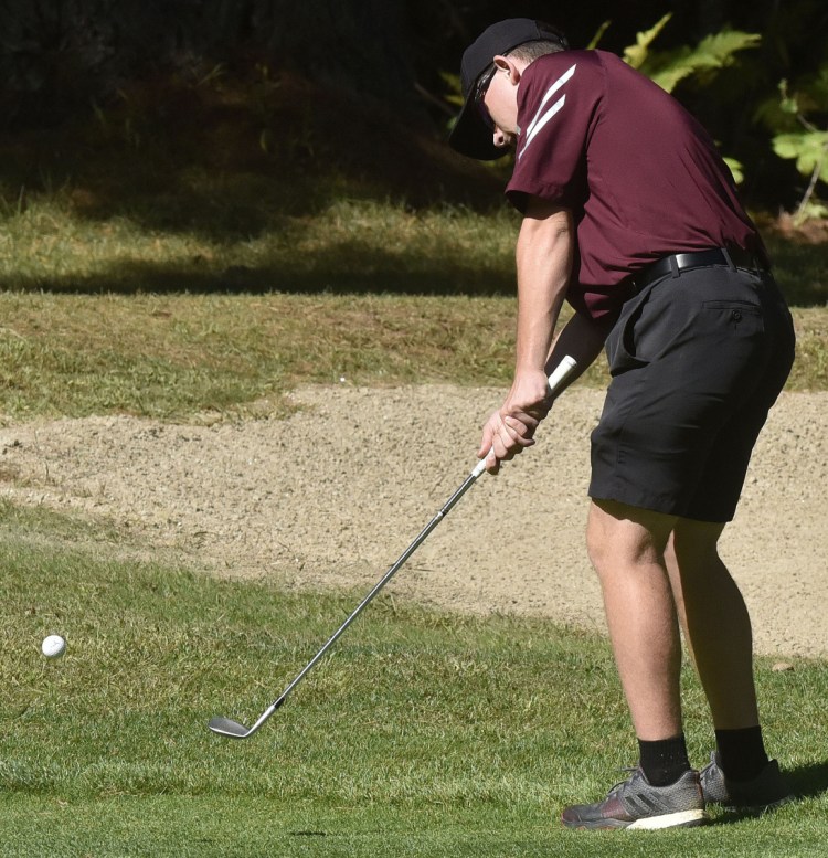 Staff photo by David Leaming 
 Monmouth's Trevor Flanagan chips a shot during the Mountain Valley Conference championships Thursday at Natanis Golf Course in Vassalboro.