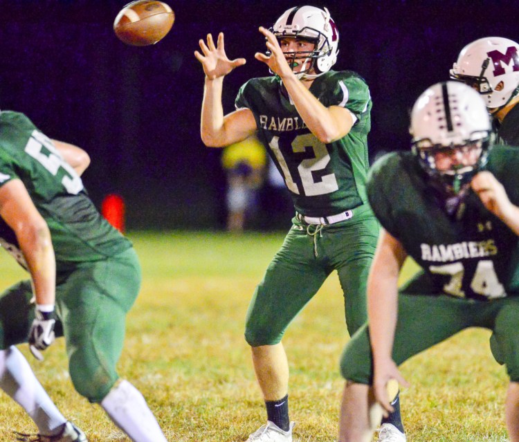 Winthrop/Monmouth/Hall-Dale quarterback Keegan Choate takes a snap against Maranacook on Friday at Maxwell Field in Winthrop.