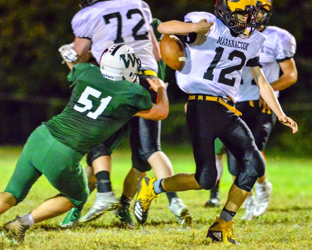 Winthrop/Monmouth/Hall-Dale linebacker Keegan Gruver, left, knocks the ball loose as Maranacook's Hunter Glowa runs with it during a game Friday at Maxwell Field in Winthrop. Maranacook recovered the fumble and even made a first down on the play.