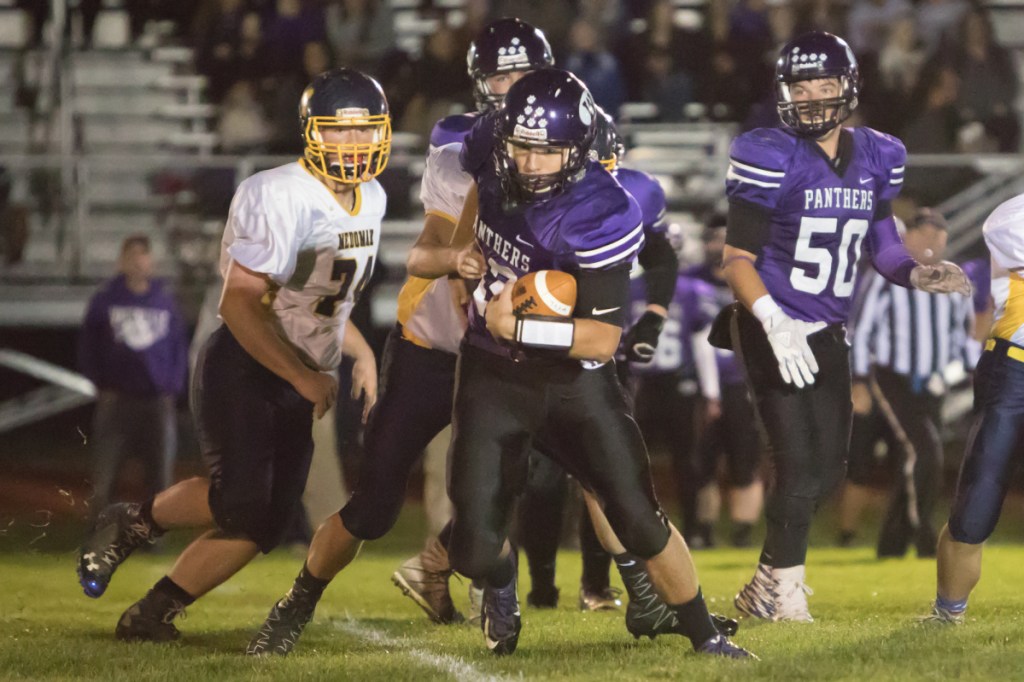 Waterville quarterback Jack Thompson carries the ball in a game against Medomak Valley on Friday night in Waterville.