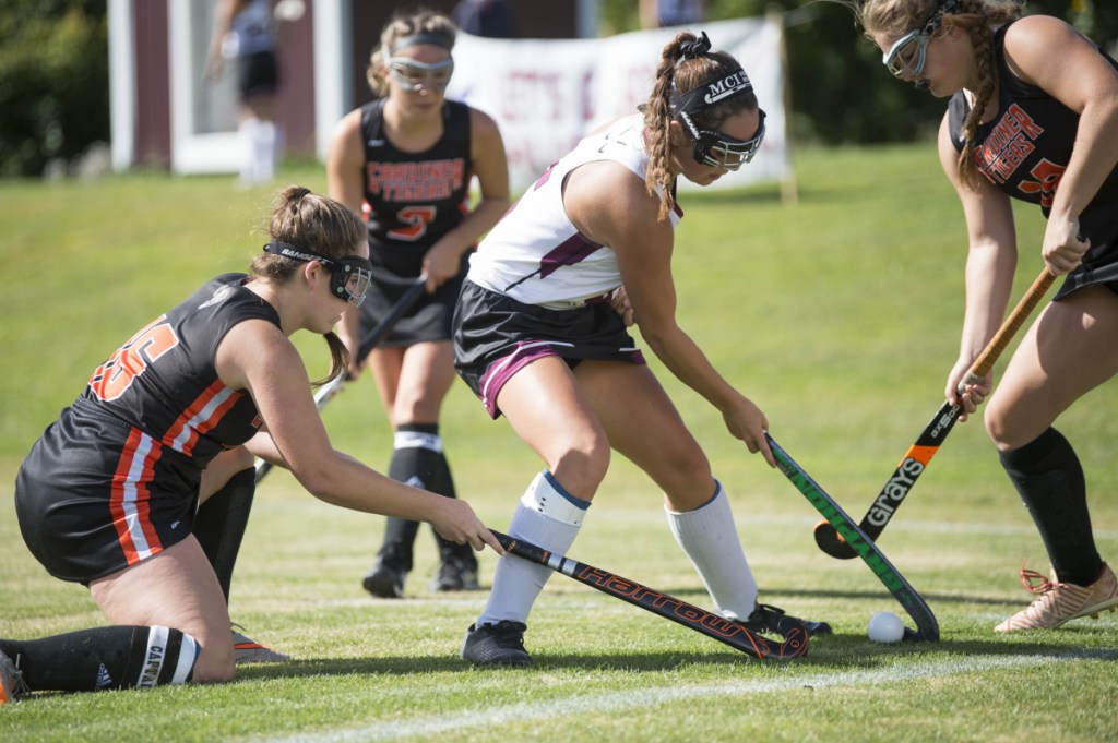 Staff photo by Michael G. Seamans 
 Maine Central Institute's Madisyn Hartley, center, looks to get by Gardiner defenders Jillian Bisson, left, and Lindsay Bell, right, on Saturday in Pittsfield.