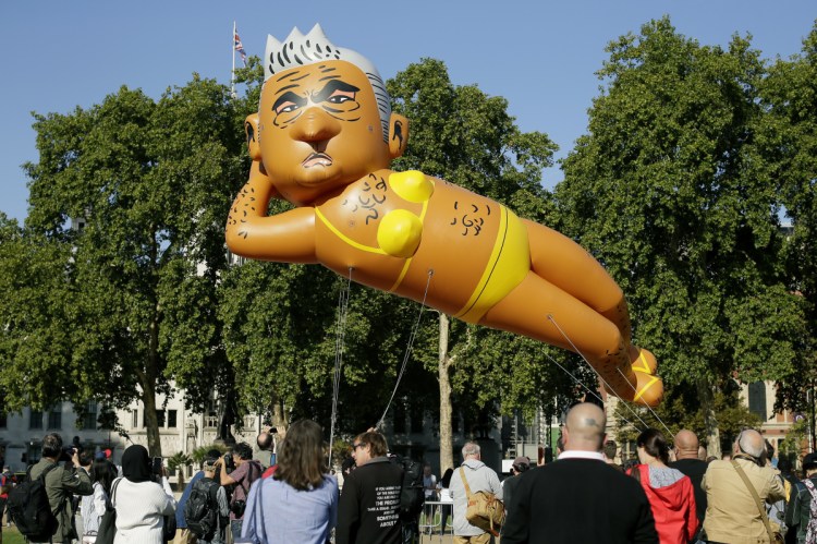 An inflatable caricature balloon of Mayor of London Sadiq Khan is released over Parliament Square in London on Saturday.
