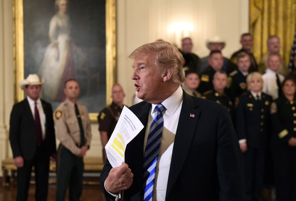 President Trump responds to a reporter's question Wednesday during an event at the White House. Responding to the critical New York Times opinion piece by an anonymous administration official, Trump said, "They don't like Donald Trump and I don't like them."