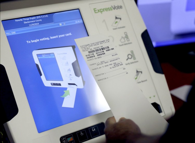 A new voting machine prints a paper record at a polling site in Georgia last year. A report from the National Academy of Sciences calls for more-secure voting systems that use paper ballots or equivalents.