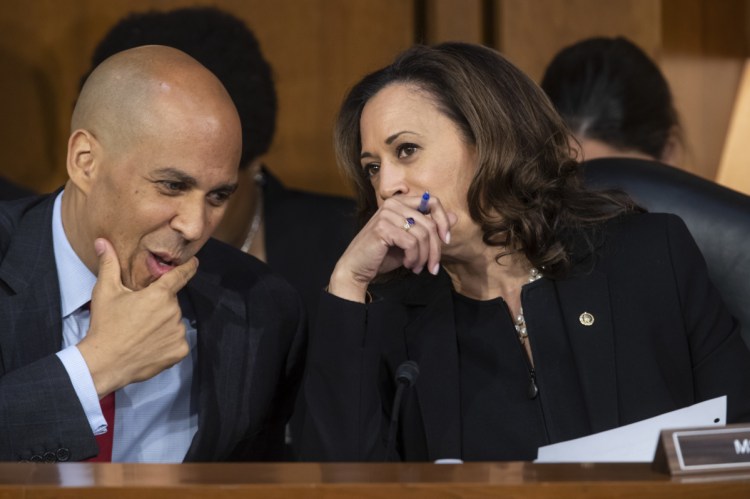 Sen. Cory Booker, D-N.J., left, and Sen. Kamala Harris, D-Calif., confer before questioning Supreme Court nominee Brett Kavanaugh as he testifies before the Senate Judiciary Committee on the third day of his confirmation hearing on Capitol Hill in Washington. 