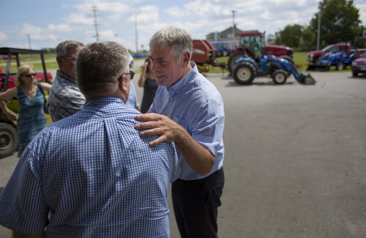 On the campaign trail, Republican gubernatorial candidate Shawn Moody of Gorham interacts last month with Rodney Ingraham, owner of Ingraham Equipment in Knox. Not long after joining the party, Moody crushed three experienced rivals in the GOP primary last June.