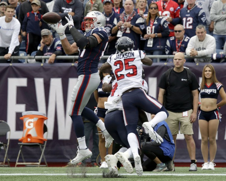 New England Patriots tight end Rob Gronkowski catches a pass in front of Houston Texans defensive back Kareem Jackson during the season opener Sunday in Foxborough, Massachusetts. Gronkowski scored the first touchdown of the game and the Patriots held on to win, 27-20.