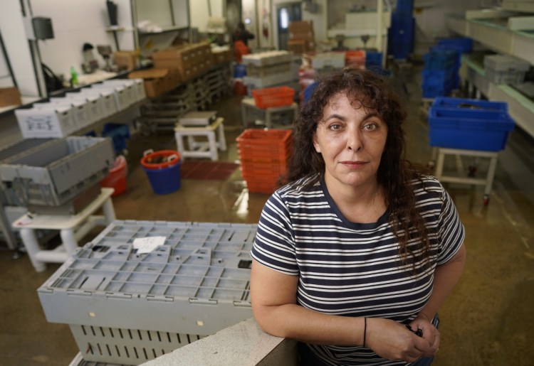 The trade war with China has forced some Maine lobster dealers like Stephanie Nadeau, owner of The Lobster Co. in Arundel, to lay off workers.