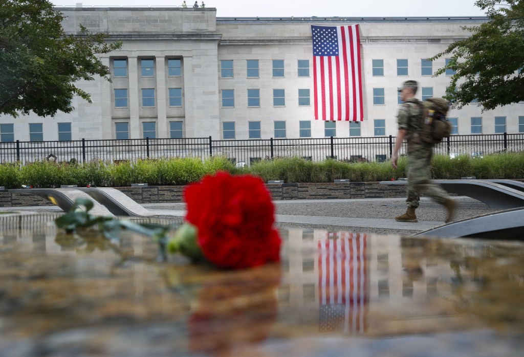 A member of the military walks the grounds of the National 9/11 Pentagon Memorial before the start of the September 11th Pentagon Memorial Observance at the Pentagon.
