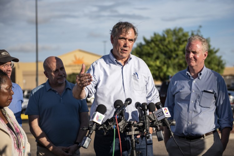 Sen. Jeff Merkley, D-Ore., second from right, speaks to members of the media outside of the Southwest Key-Casa Padre Facility, in Brownsville, Texas in June.