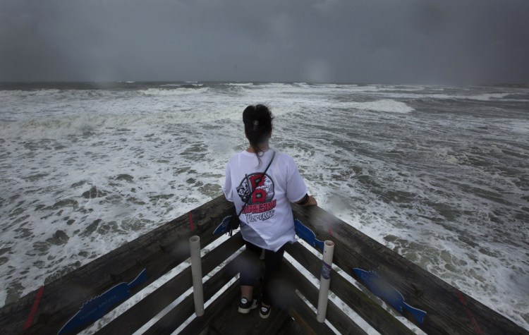 Kimberly Lancaster takes in the view from Avalon Fishing Pier in Kill Devil Hills, N.C., on Thursday. The storm surge is expected to be 7 to 11 feet above sea level.