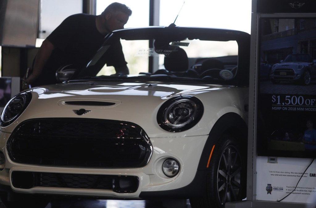 A prospective buyer looks over a 2019 Mini Cooper S convertible on the showroom floor of a dealership in Highlands Ranch, Colo., late last month. The Commerce Department said retail sales rose just 0.1 percent in August.