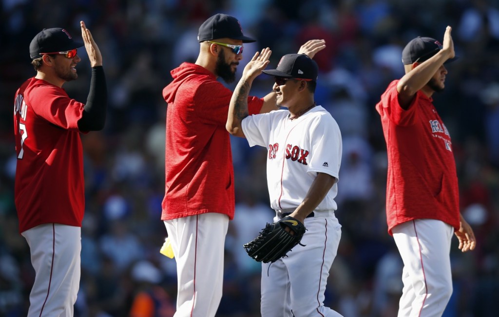 Boston Red Sox's Tzu-Wei Lin, center right, celebrates with pitchers, from left, Nathan Eovaldi, David Price and Eduardo Rodriguez after a 4-3 win Sunday against the New York Mets.