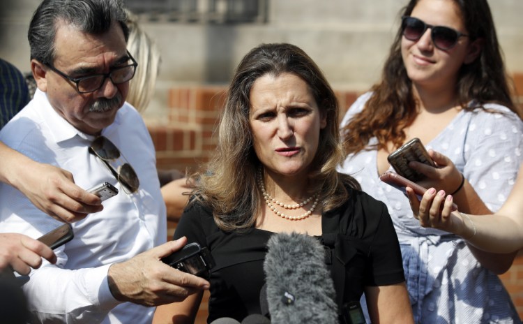 Canadian Foreign Affairs Minister Chrystia Freeland, center, speaks to the media as she arrives at the Office of the United States Trade Representative.