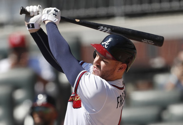 Atlanta's Freddie Freeman follows through for a two-run home run in the fourth inning of the Braves' 7-3 victory over the Cardinals on Wednesday in Atlanta. The Braves stopped a four game-losing streak and have a magic number of six to clinch the NL East.