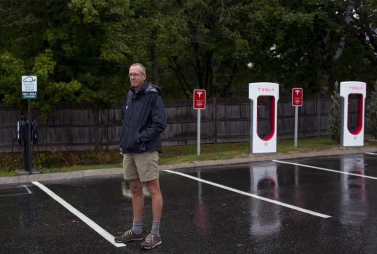 Bill Yeo, L.L. Bean Outdoor Discovery School's retail manager, poses for a portrait in front of the store's new electric car charging stations. Yeo said if electric vehicles take off he "hopes the whole parking lot will someday be an EV charging station."