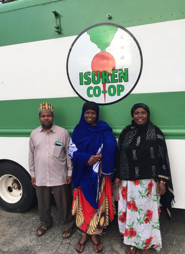 Isaack Gawo, Ghali Farrah and Isnino Ibrahim in front of the Isuken Co-op food truck.