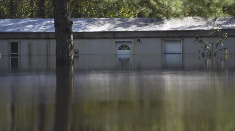 Severe flooding from the Northeast Cape Fear River after torrential rains from Hurricane Florence is seen in Burgaw, N.C., Wednesday. Frustration and exhaustion were building as thousands of people waited to go home seven days after the storm began battering the coast.