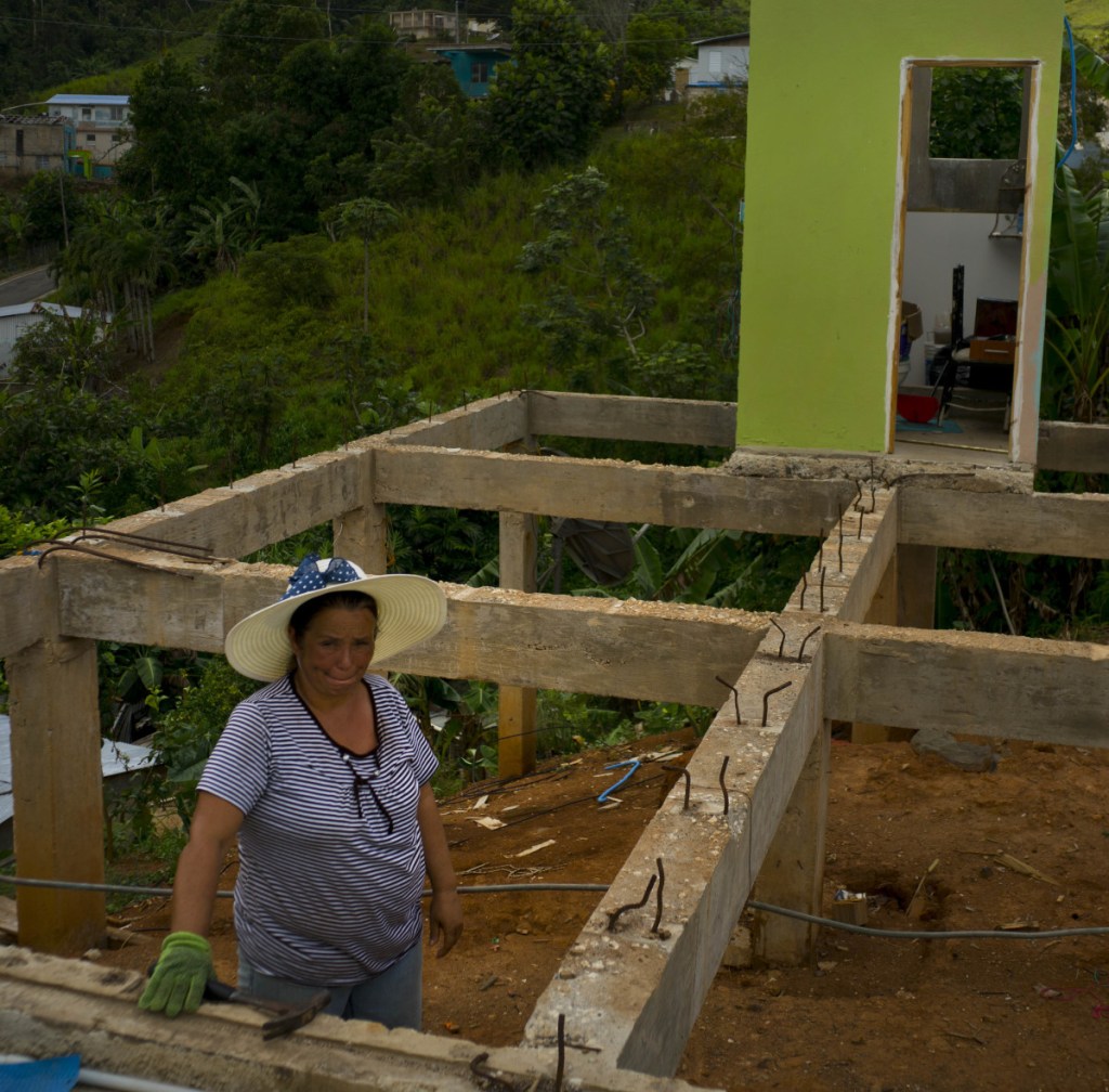 Alma Morales Rosario poses between the beams of her home being rebuilt after it was destroyed by Hurricane Maria one year ago in the San Lorenzo neighborhood of Morovis, Puerto Rico.
Associated Press/Ramon Espinosa