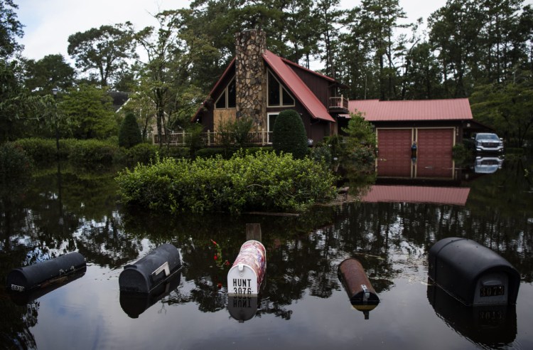Homes are surrounded by floodwaters in Lumberton, N.C., in the aftermath of Hurricane Florence on Monday. At least 42 people have died in a disaster that seems like it won't end.