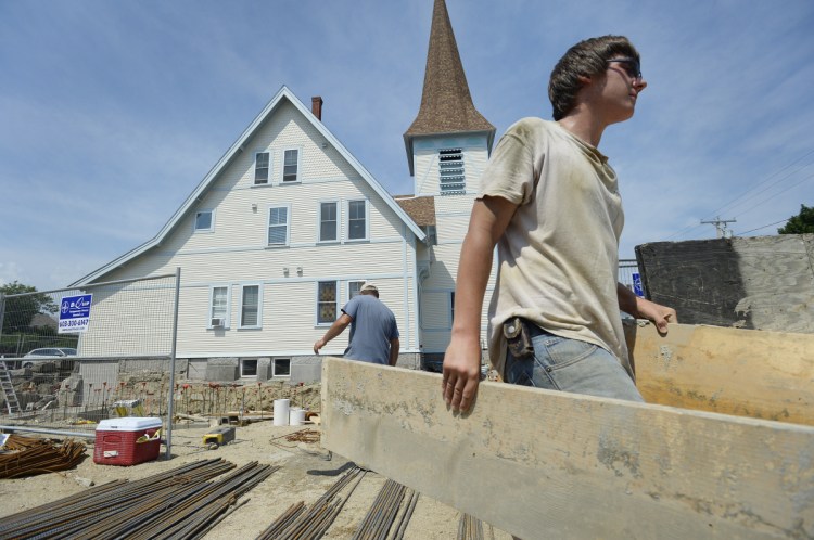 Brandon Norton works at the site of a future Cutts Avenue apartment complex in Saco, which had a 26 percent surge in permits over five years. Saco saw $38 million in new construction value in 2017.